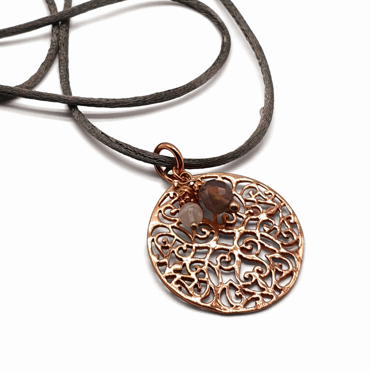Rose gold amulet with silk ribbon